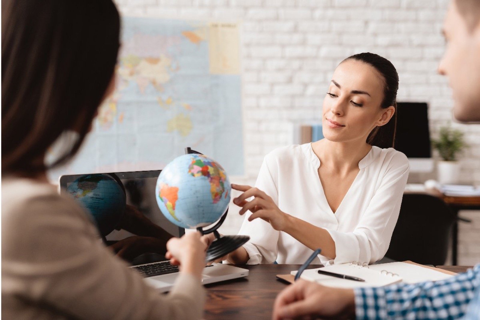 Consultant reviewing a world map and global placement options